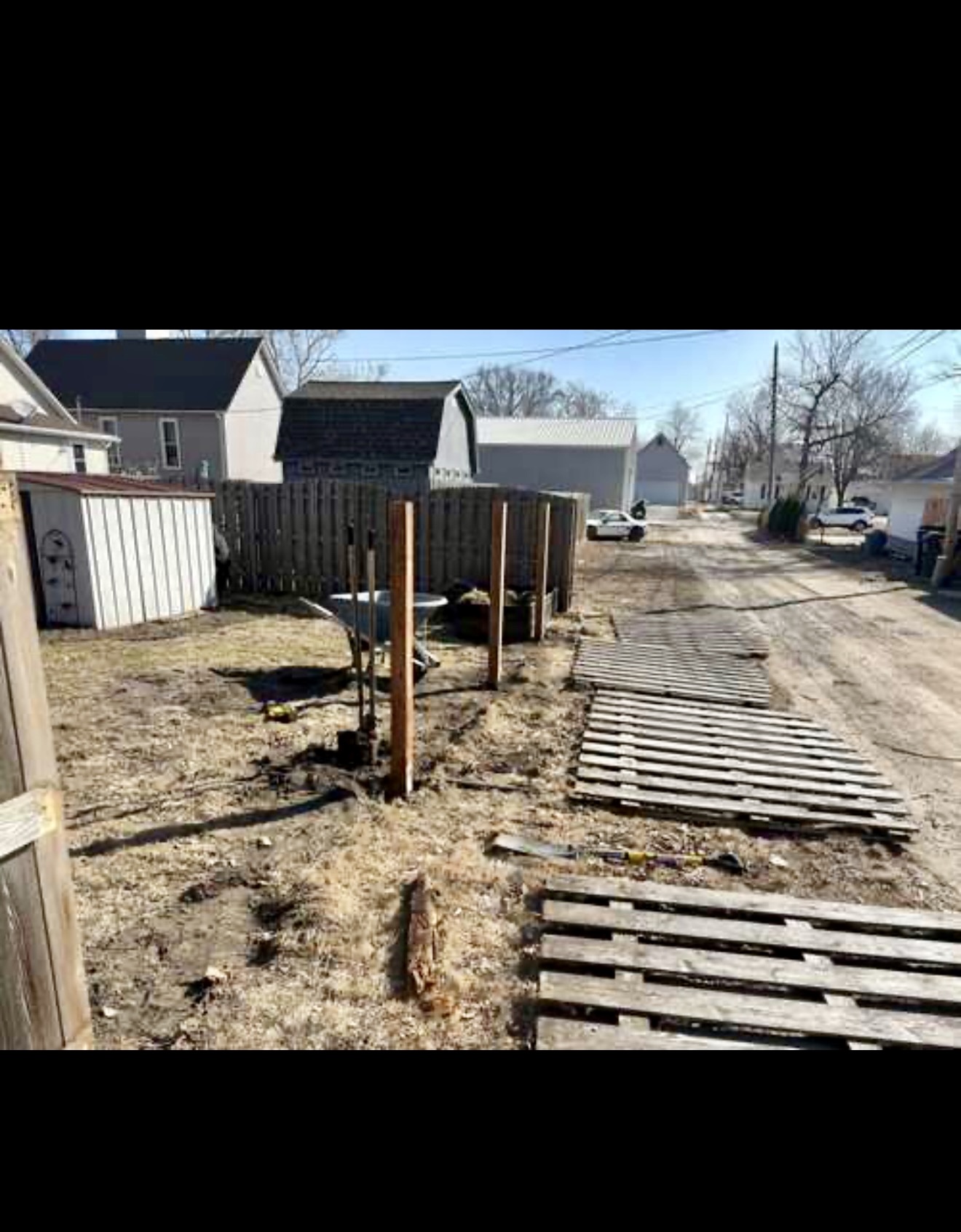 Wood fence repair project with scalloped fence detail