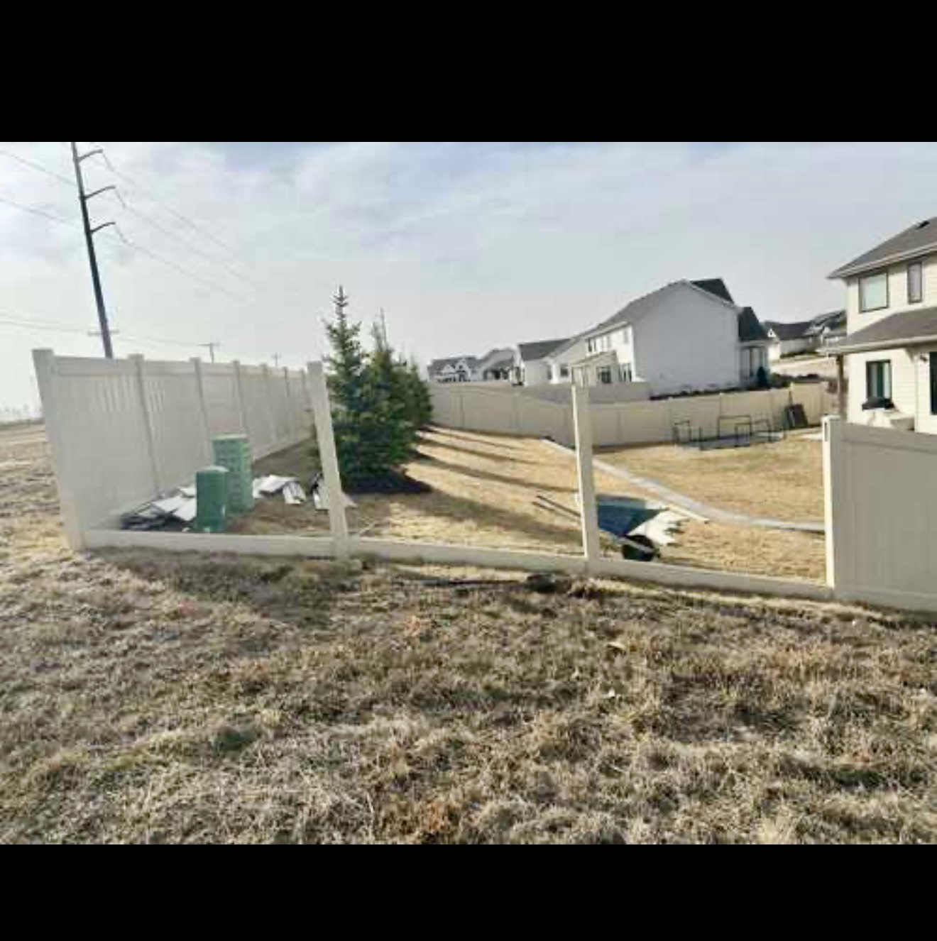 Brown vinyl fence repair project showing the fence before completion
