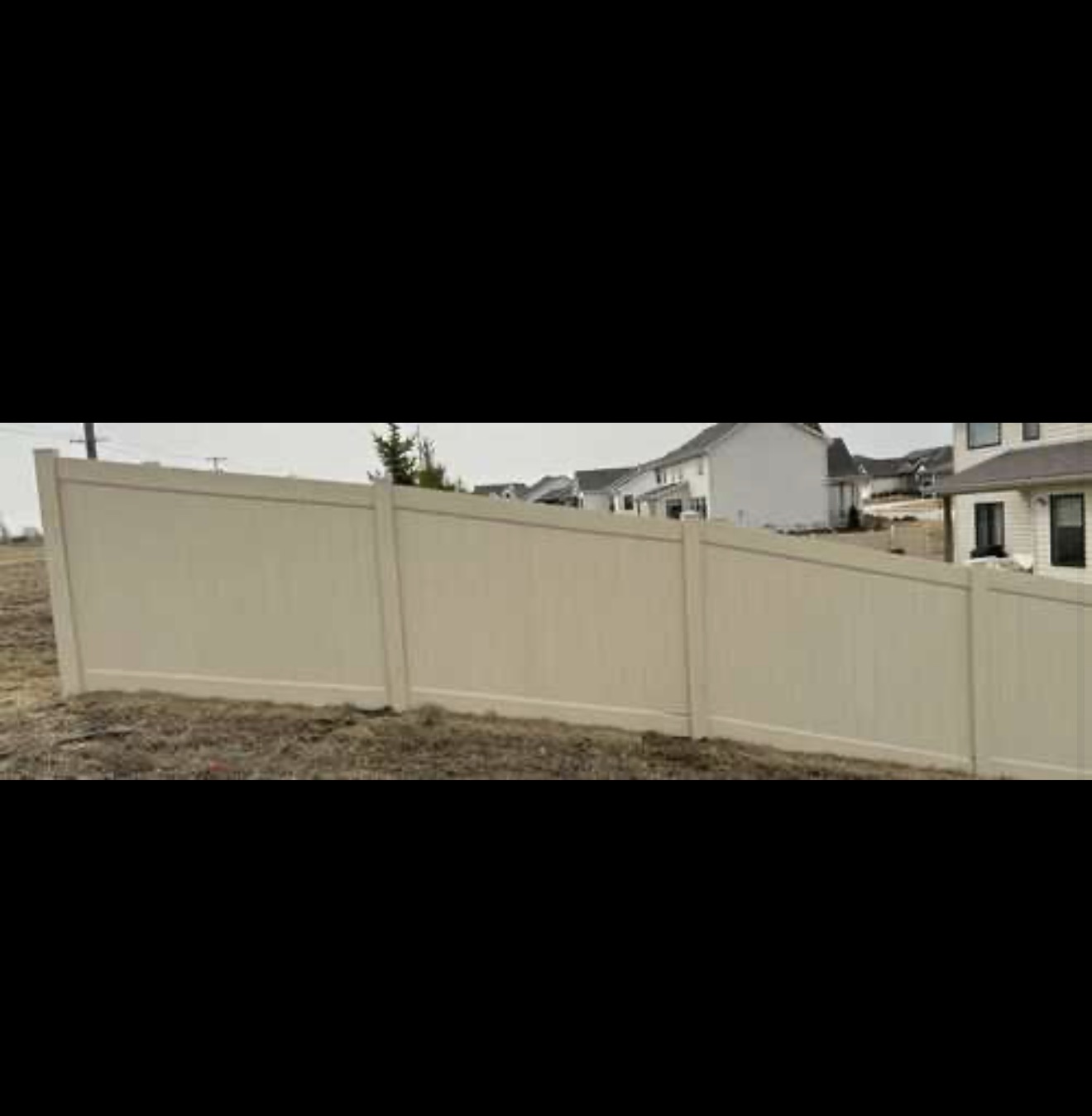 Brown vinyl fence repair project after completion